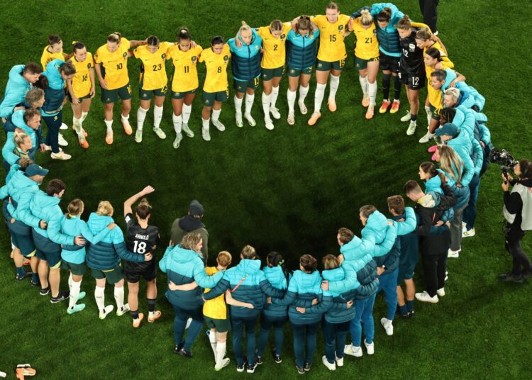 Australia's players gather after losing the Australia and New Zealand 2023 Women's World Cup semi-final football match between Australia and England at Stadium Australia in Sydney on August 16, 2023. (Photo by DAVID GRAY / AFP)
