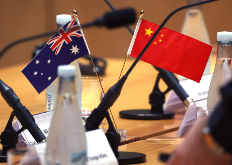 China's and Australia's flags are seen on the tables where China's Foreign Minister Wang Yi and Australia's Foreign Minister Penny Wong are due to hold their bilateral meeting at Parliament House in Canberra on March 20, 2024. - China's Foreign Minister Wang Yi began a whirlwind visit to Australia on March 20, his rare trip marking a thaw in relations between the two trading partners. (Photo by DAVID GRAY / AFP)