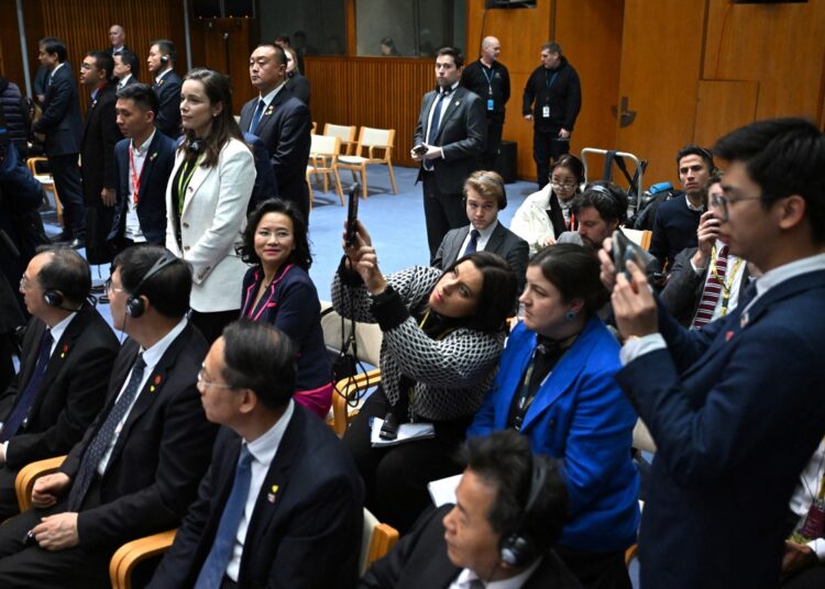 Australian journalist Cheng Lei (middle row L) attends a signing ceremony by China's Premier Li Qiang and Australia's Prime Minister Anthony Albanese at the Australian Parliament House in Canberra on June 17, 2024. - Australia expressed its "concern" to China on June 18 after two diplomats at a ceremonial event were accused of clumsily shadowing a high-profile journalist who spent three years detained in China. (Photo by LUKAS COCH / POOL / AFP)